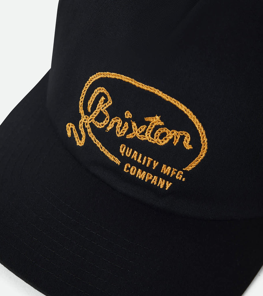 Black cap with gold embroidered text on a white background