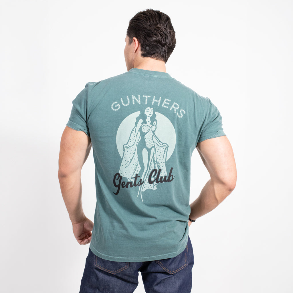 Man wearing a teal t-shirt with 'Gunthers Gentle Club' design on the back, on a white background