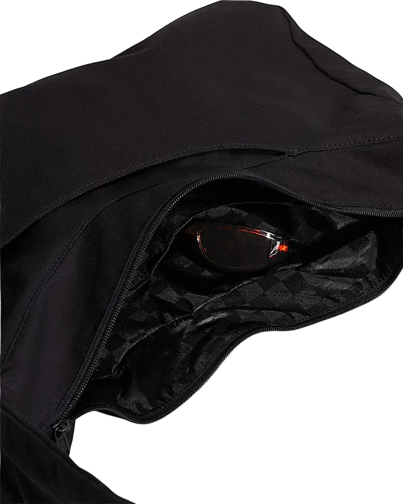 Black tote bag open, revealing sunglasses inside on a light gray background