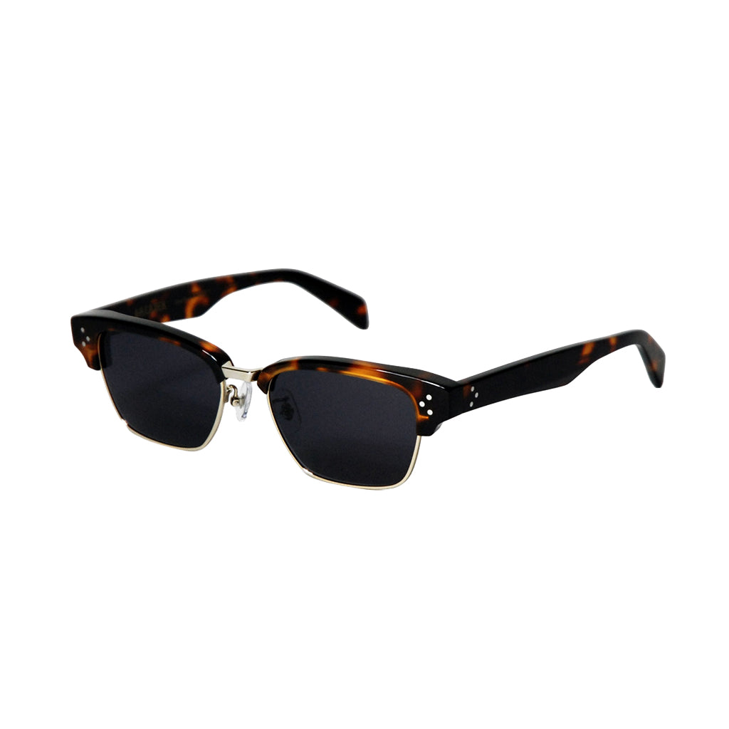 Half rimmed sunglasses with a gold accent on a white background