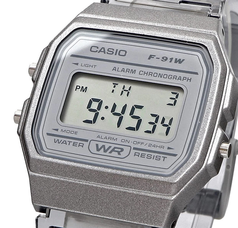 Casio digital watch with silver case and clear strap on a white background