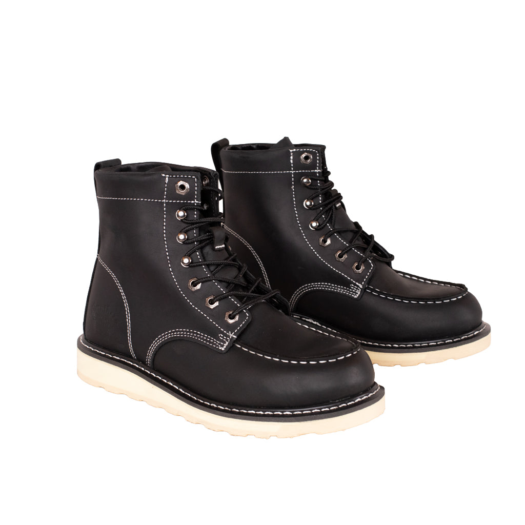 Pair of black leather boots with white soles on a white background
