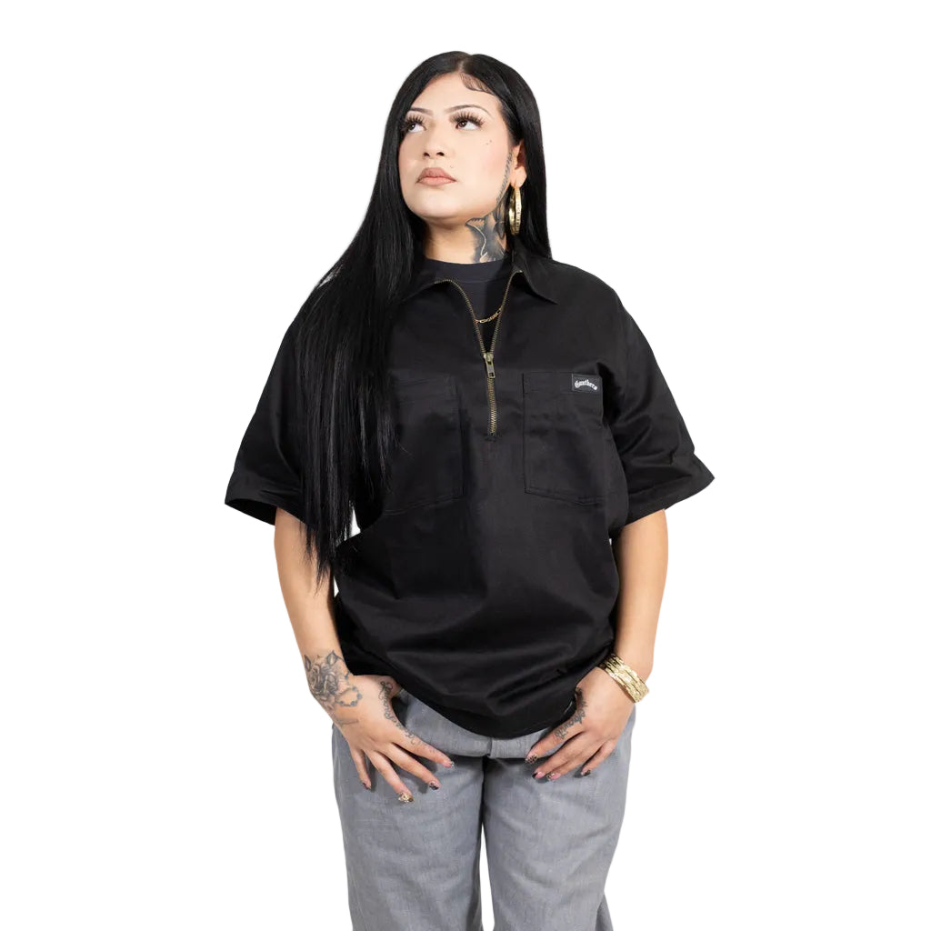 Person wearing a black short-sleeve shirt with a brand logo on a white background