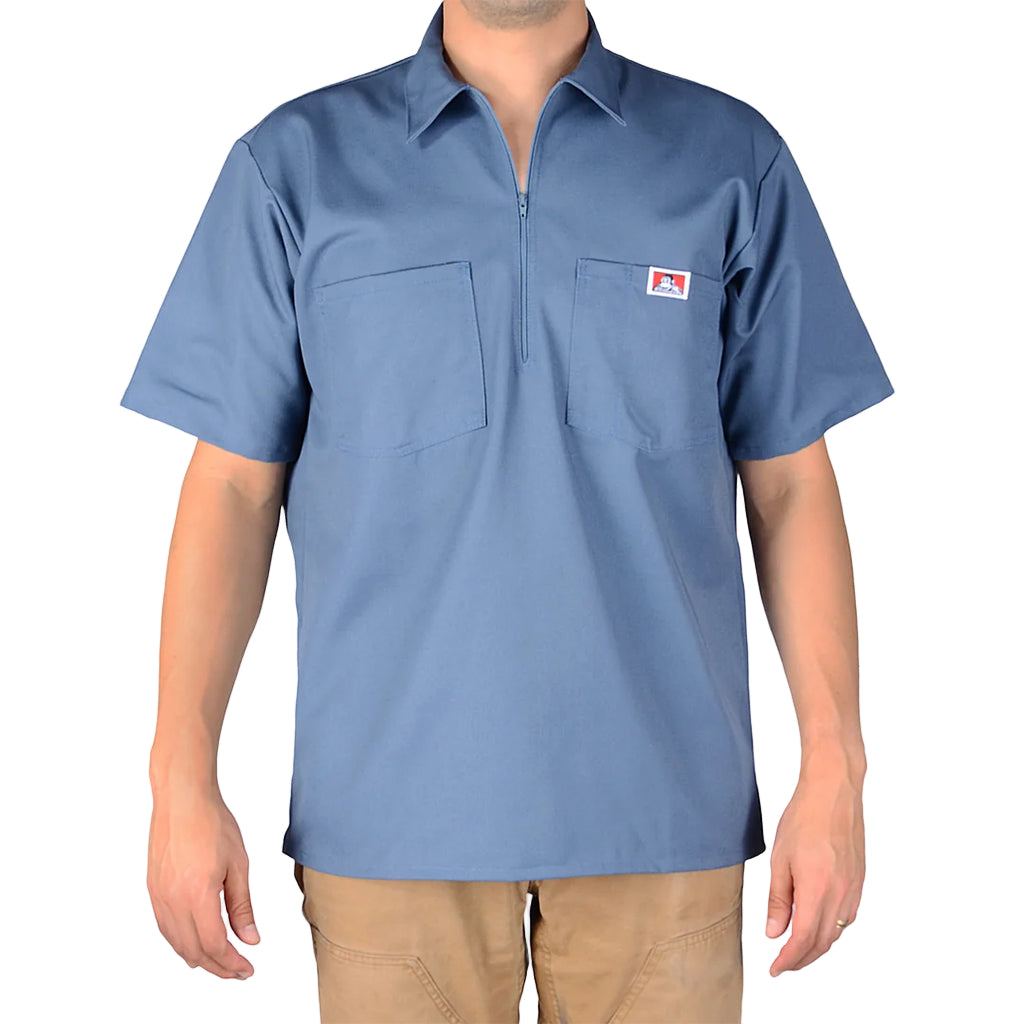 Blue short-sleeve shirt with a small logo on a plain background
