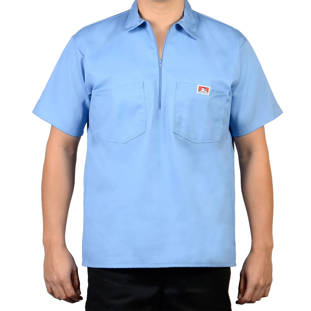 Light blue short-sleeve shirt with a small logo on a white background