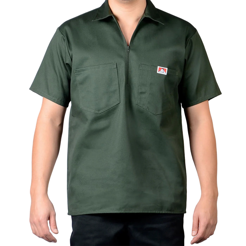 Green short-sleeve shirt with a logo on a gray background