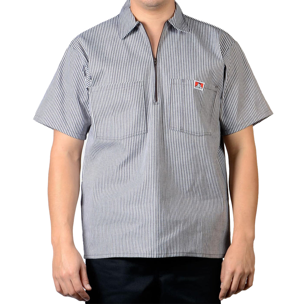 Person wearing a short-sleeve, striped brown shirt with a Ben Davis logo on a white background