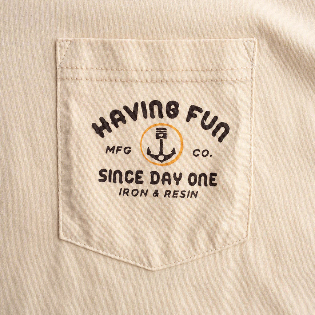 Beige shirt pocket with 'Having Fun' logo and text