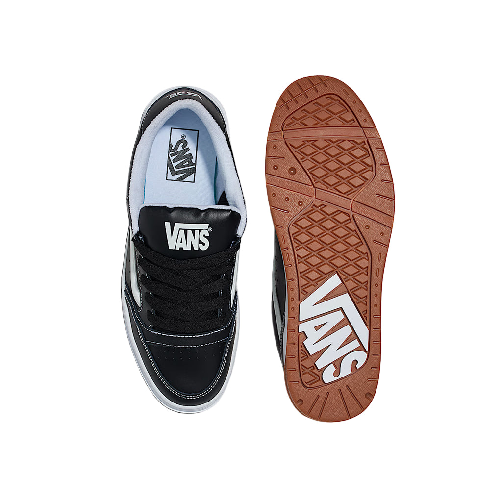 Black Vans sneaker with white sole on a white background