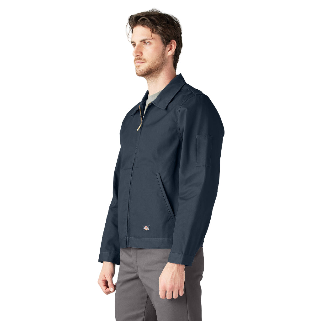 Man wearing a navy jacket and gray pants on a white background