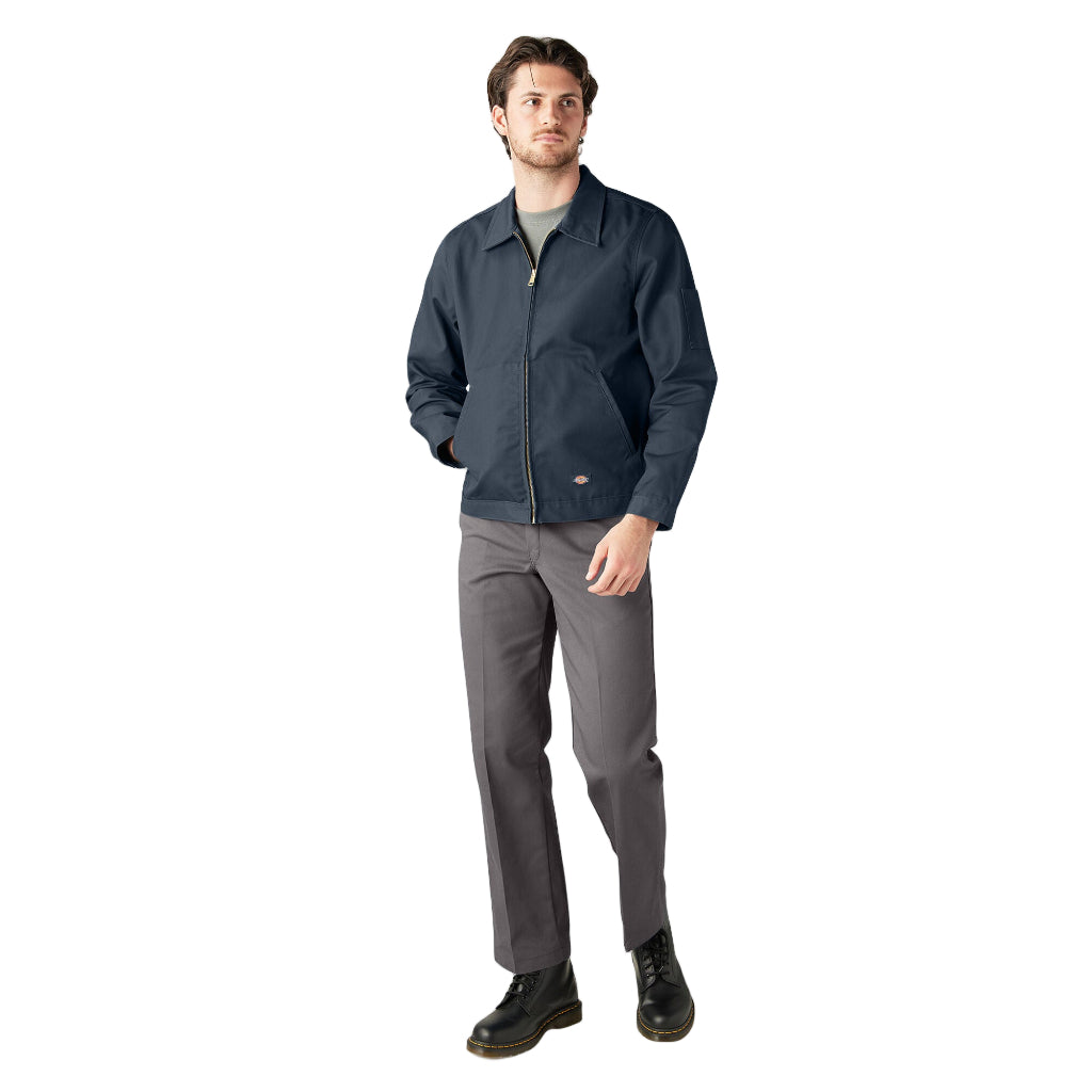 Man wearing a navy jacket and gray pants on a white background