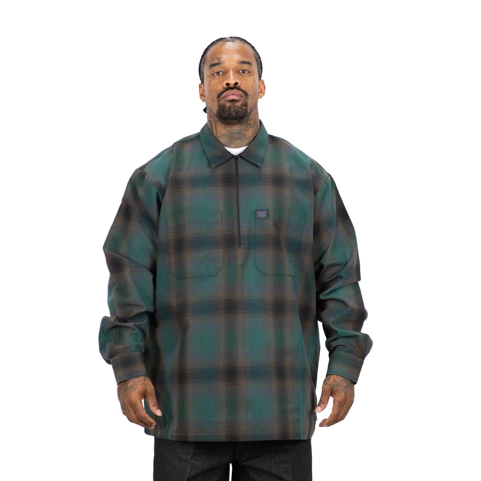 Man wearing a green plaid shirt with a visible brand logo on a white background