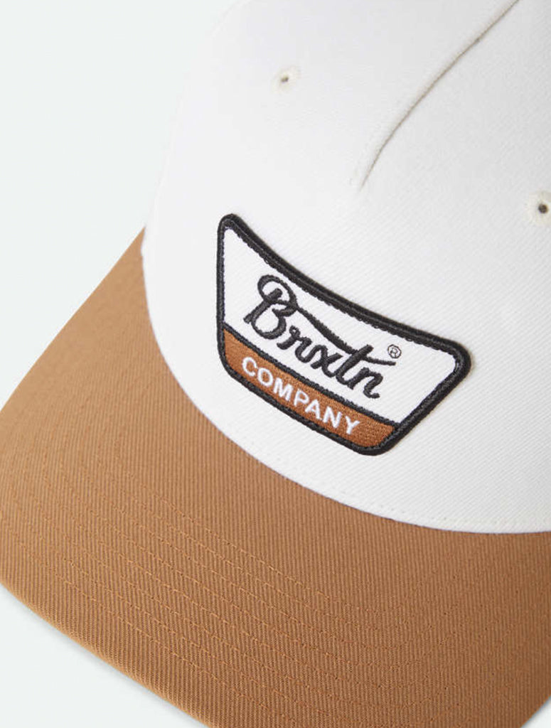 Close-up of a cap with a logo on a white background