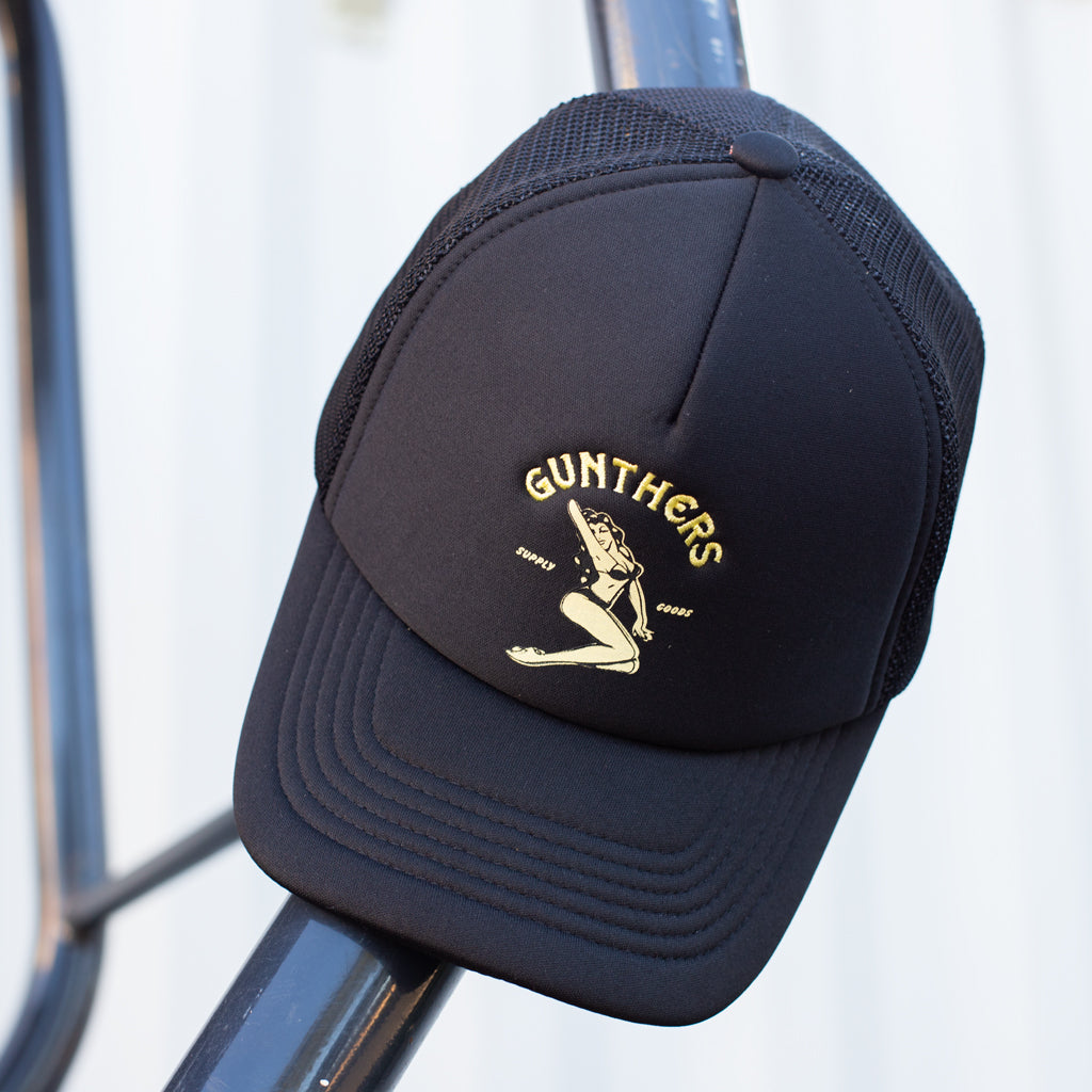 Black cap with 'Gunthers' logo on a blurred background