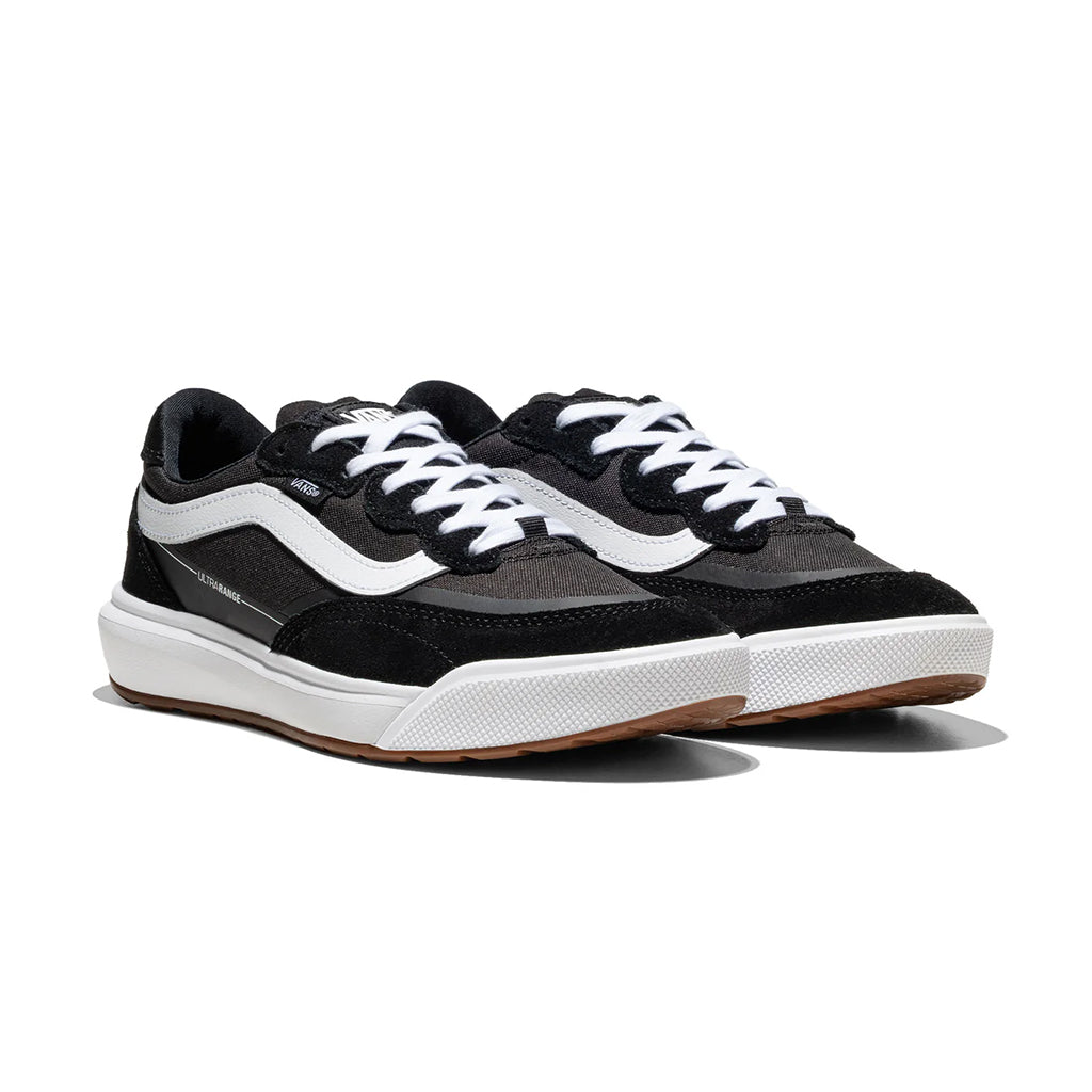 Black and white sneakers with brown soles on a white background