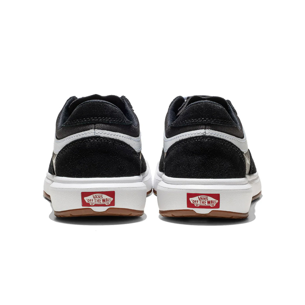 Black and white sneakers with red label on a white background