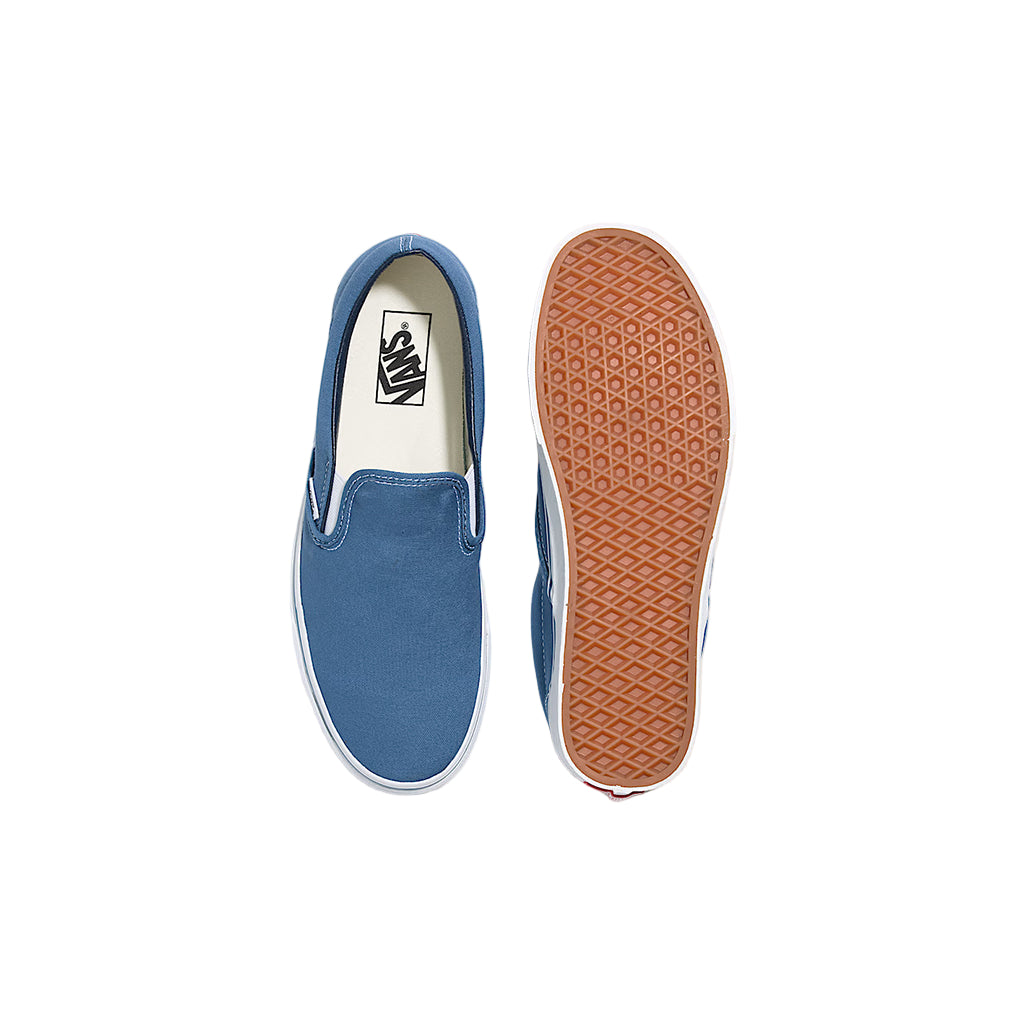 Blue slip-on sneaker with brown sole on a white background