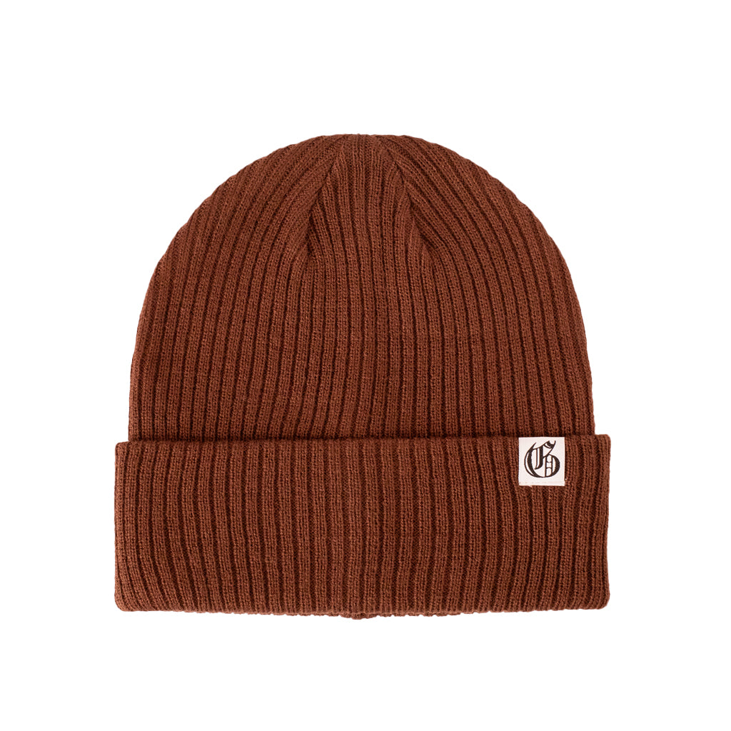 Brown knit beanie with a logo tag on a white background