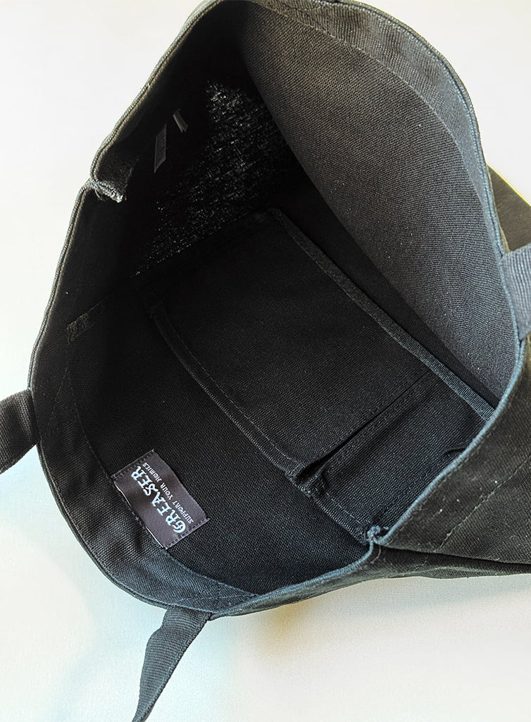 Black backpack with a visible brand label on a white background