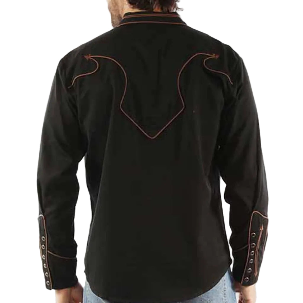 Man wearing a black embroidered shirt with blue jeans on a white background