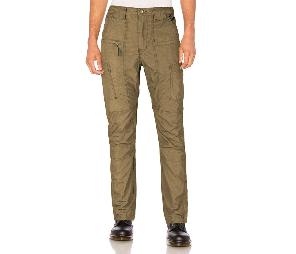Person wearing olive green pants on a white background