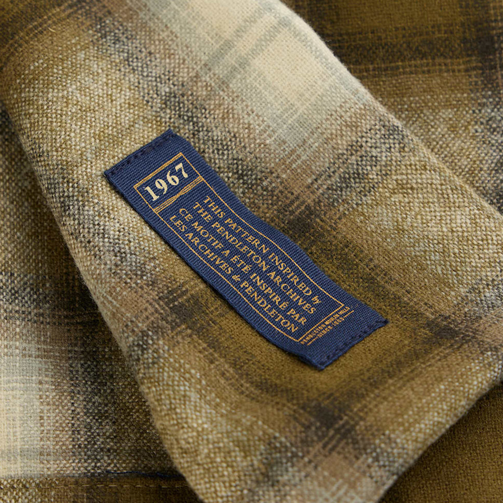 Close-up of a plaid fabric with a blue label featuring the year 1967.