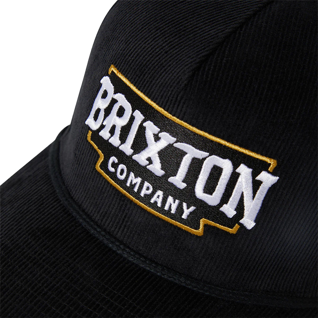 Black cap with Brixton Company logo on a white background