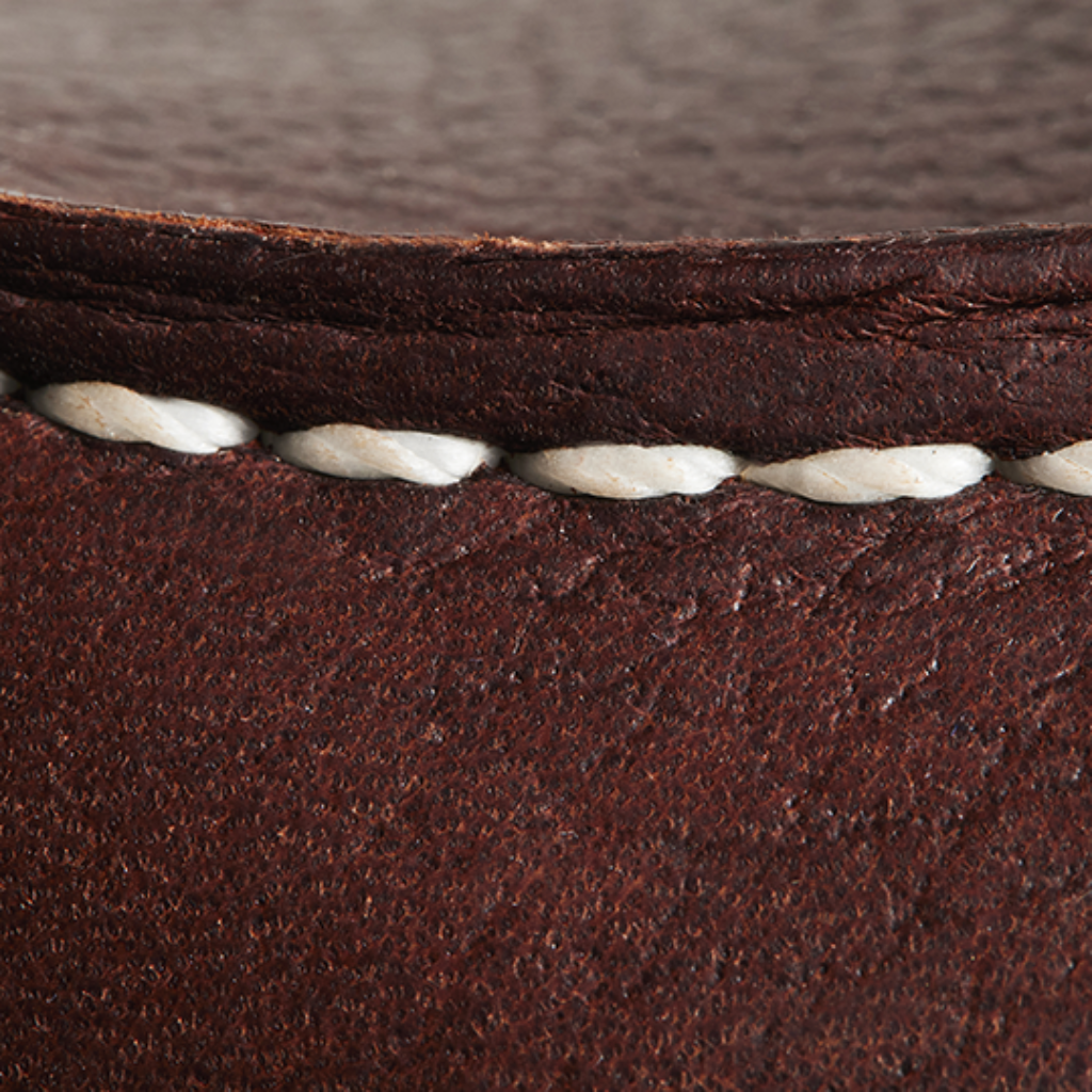Close-up of brown leather with white stitching
