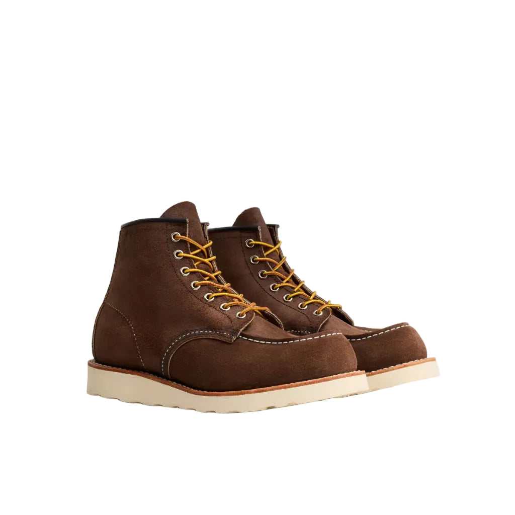 Pair of brown leather boots with yellow laces on a white background