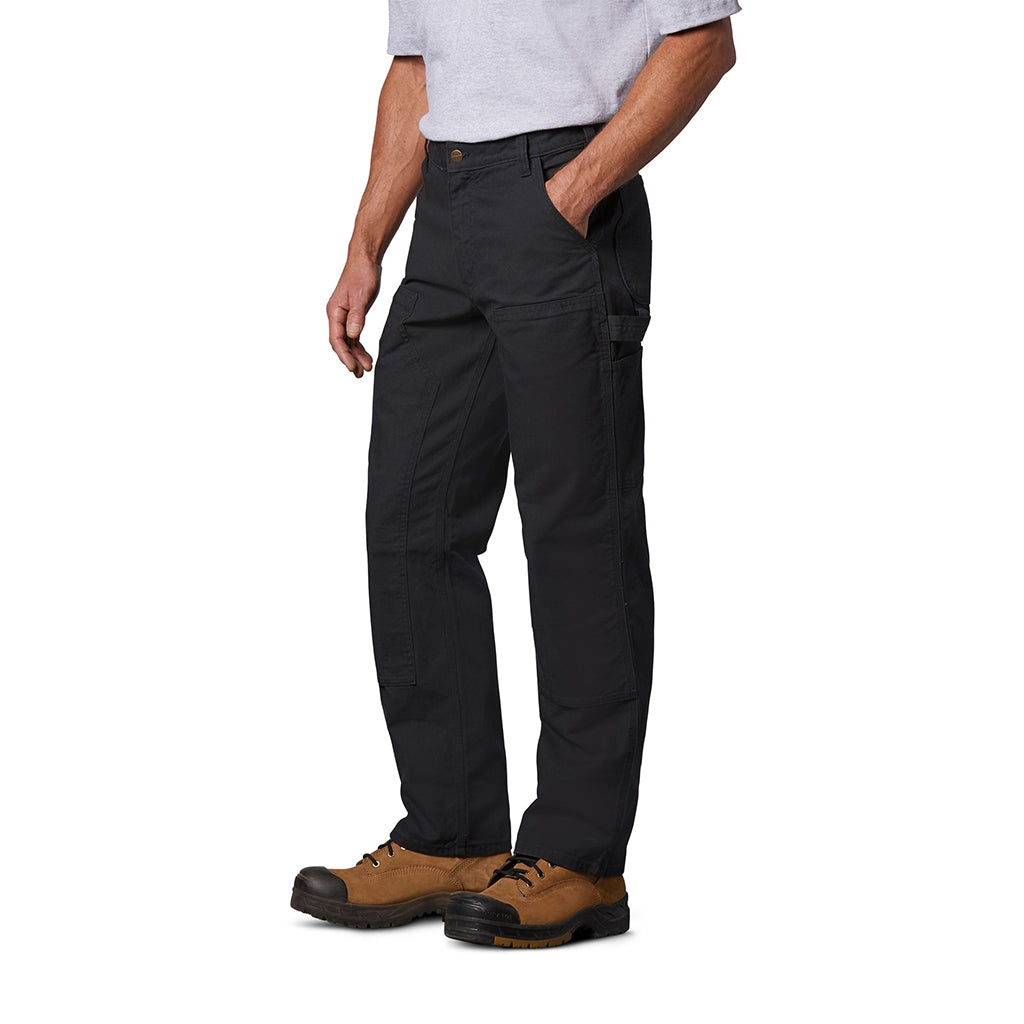 Person wearing black pants and brown boots on a white background