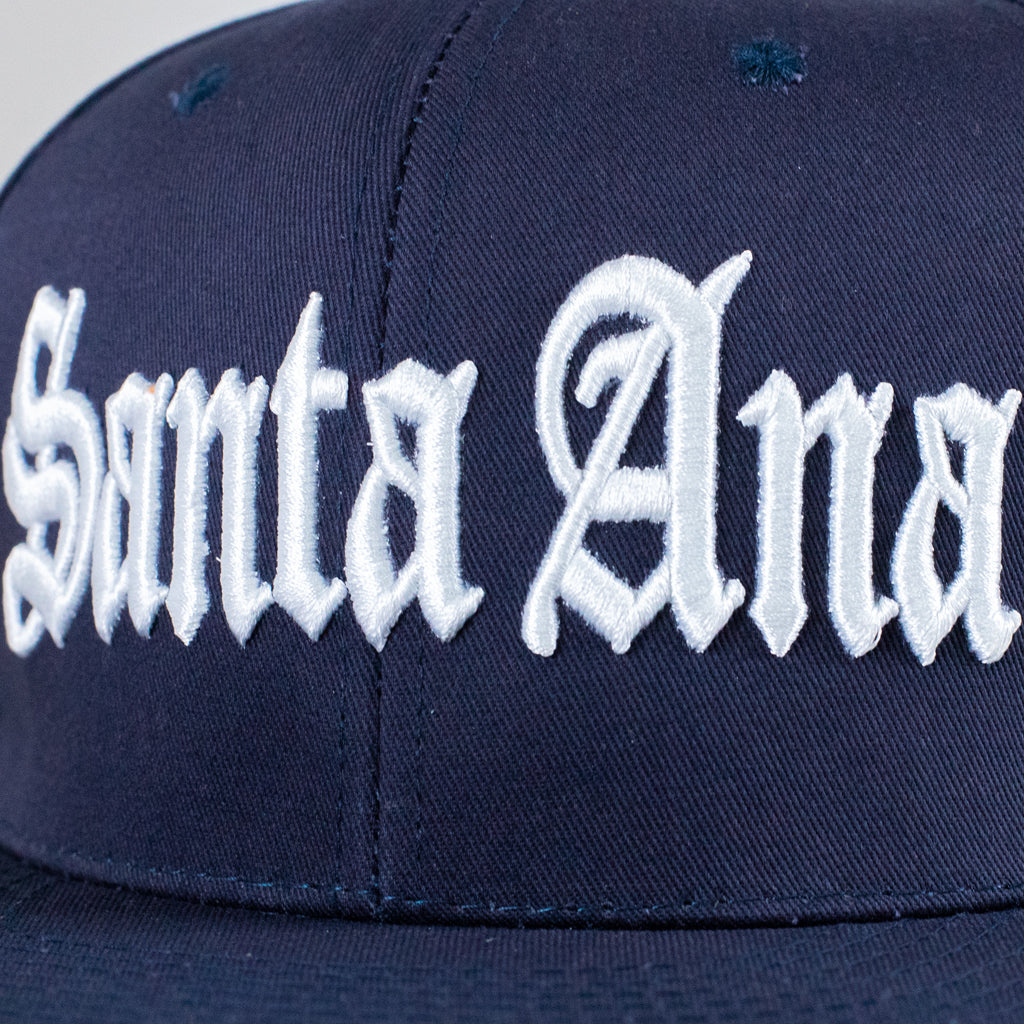 Navy blue cap with 'Santa Ana' embroidered in white on a neutral background