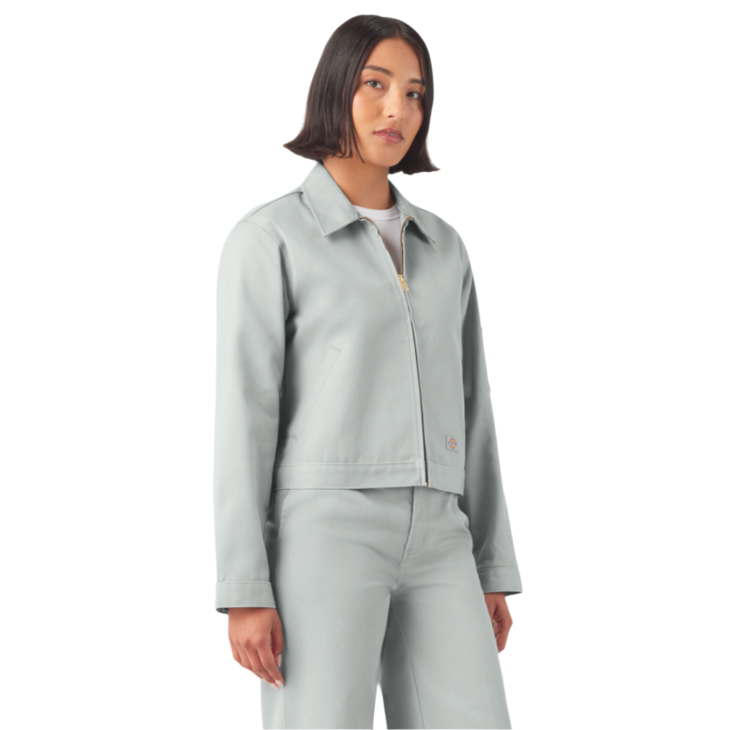 A woman wearing a cropped grey Eisenhower jacket with long sleeves, angled front welt pockets
