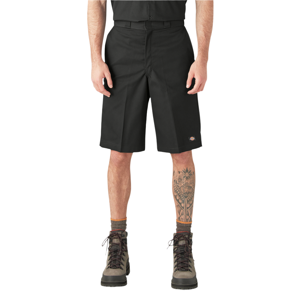 A person standing wearing loose fit 13-inch black work shorts with a flat front design, belt loops, and multiple pockets.