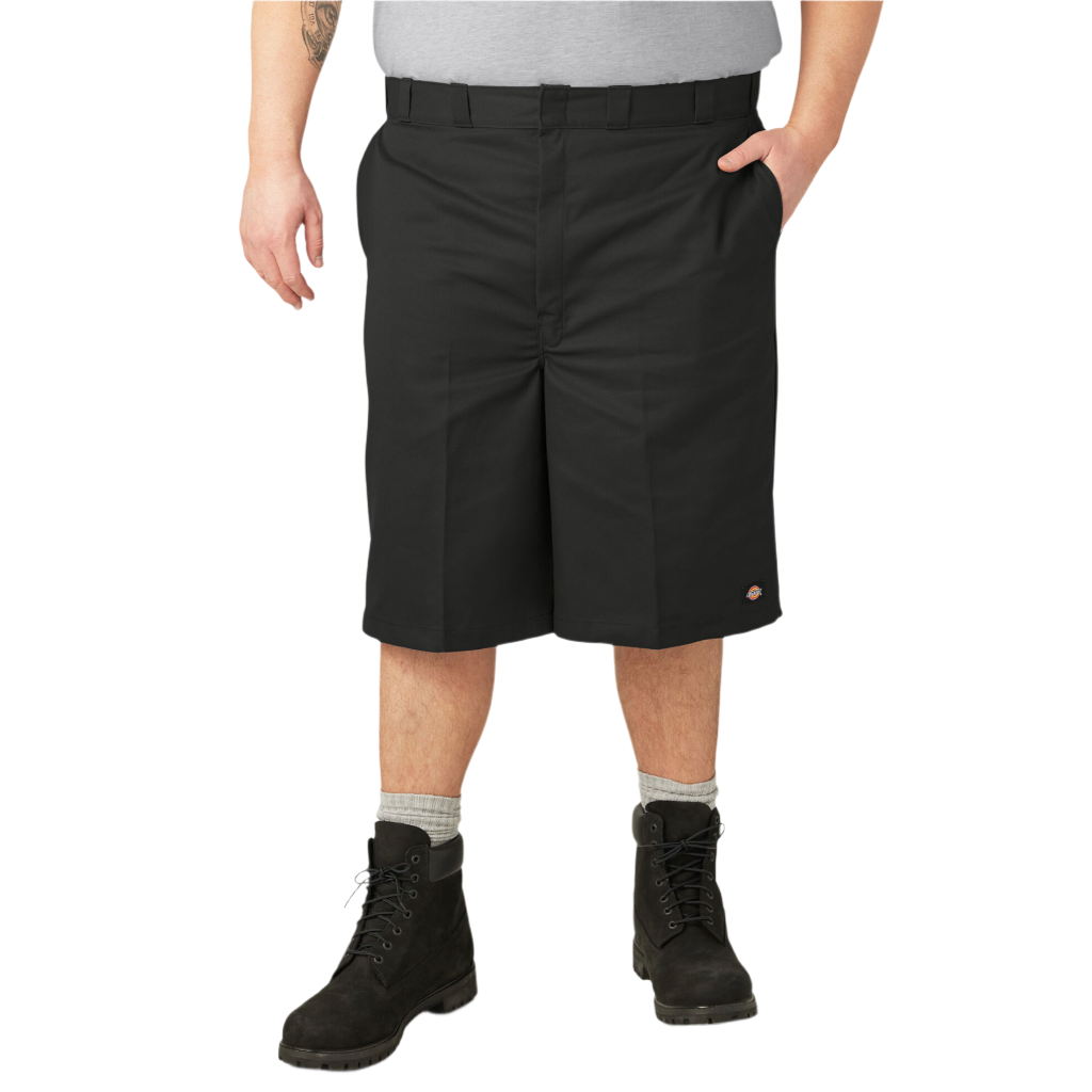 A person standing wearing loose fit 13-inch black work shorts with a flat front design, belt loops, and multiple pockets.