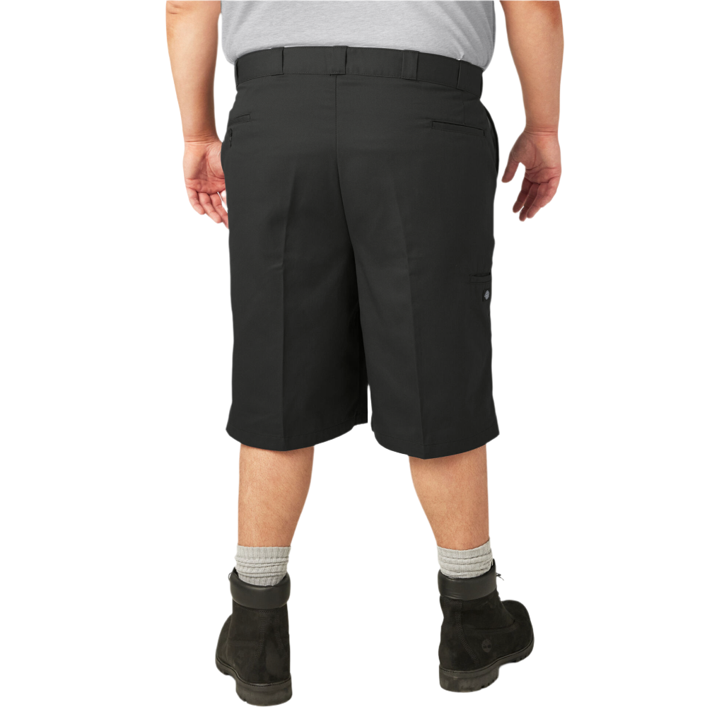 A person standing wearing loose fit 13-inch black work shorts with a flat front design, belt loops, and multiple pockets.