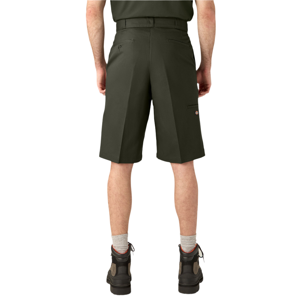 A person standing wearing olive green Dickies work shorts with a flat front design and multiple pockets, paired with a belt and boots.