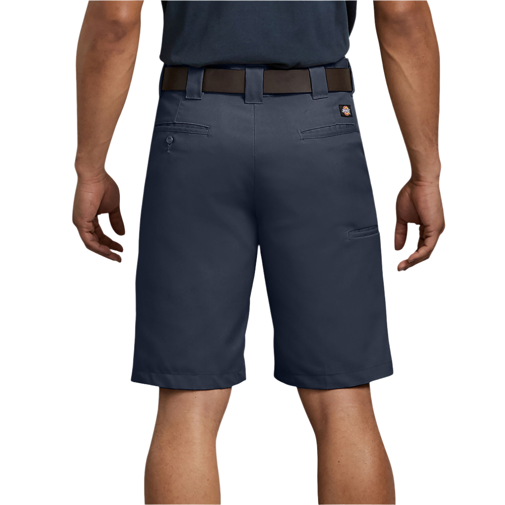 A person standing, wearing dark navy regular fit shorts with a belt showing back pockets