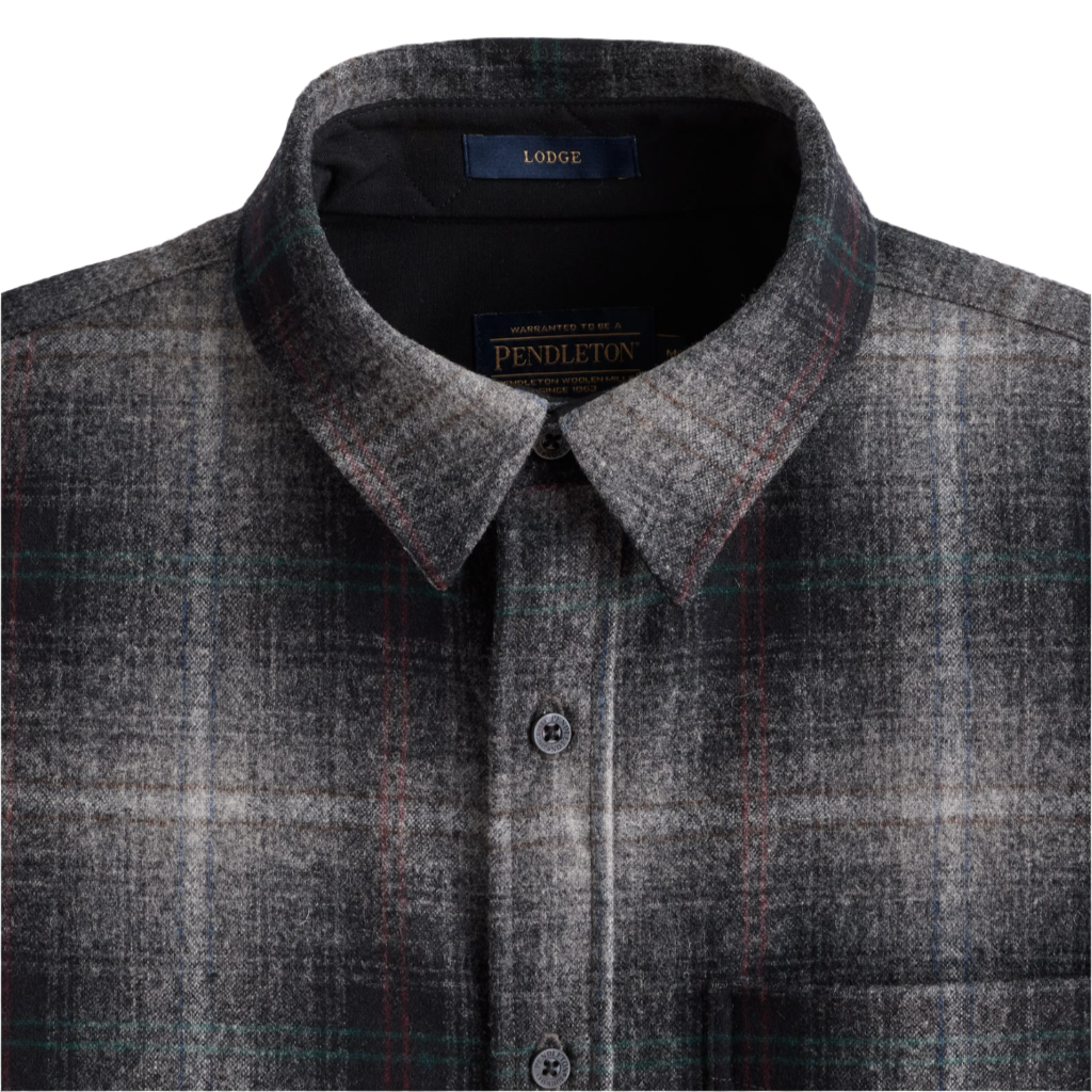 A close-up of a traditional men's plaid shirt with a spread collar and a chest pocket, featuring a grey and multicolor plaid pattern.