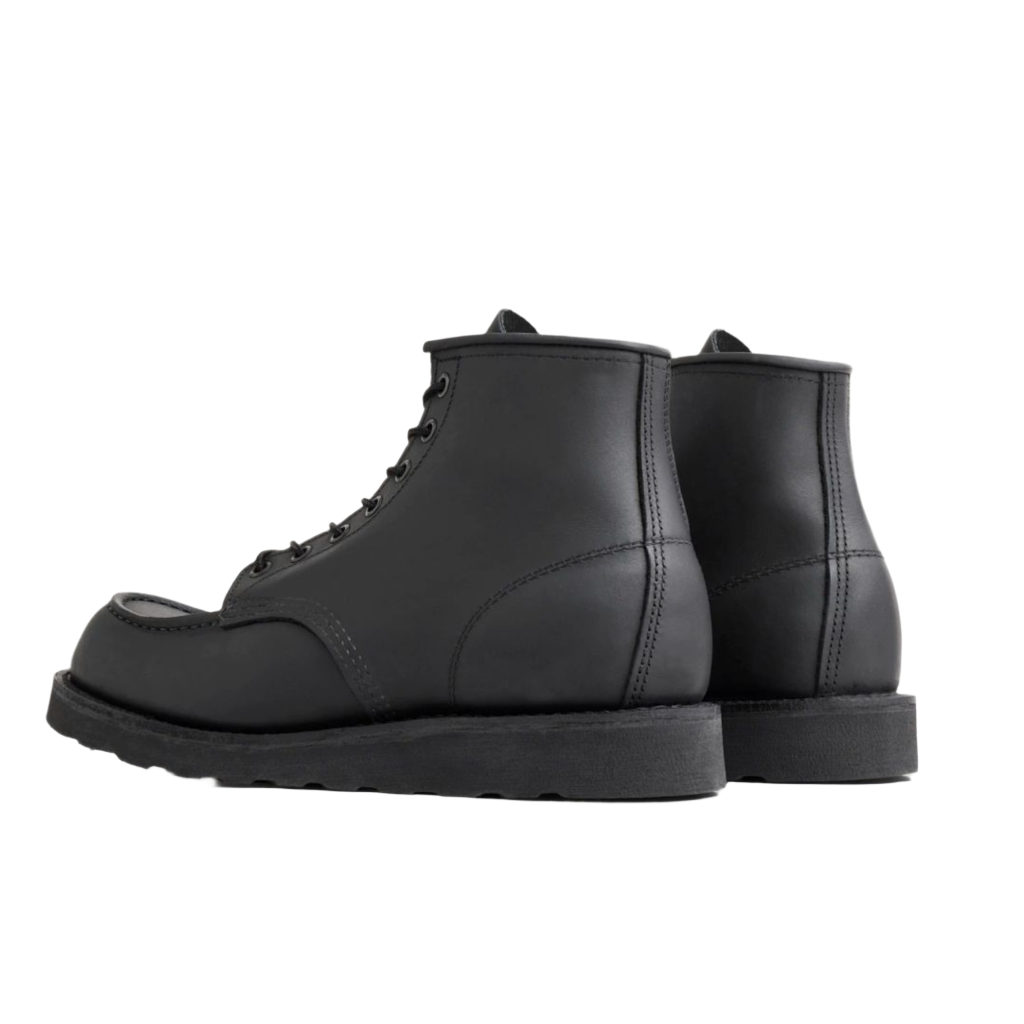 back of A pair of Red Wing Shoes 8074 Moc Toe in Black Harness, featuring a classic moccasin style with lace-up closure and a thick sole.