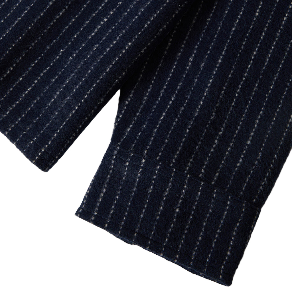 Close-up of a navy pinstripe fabric on a white background