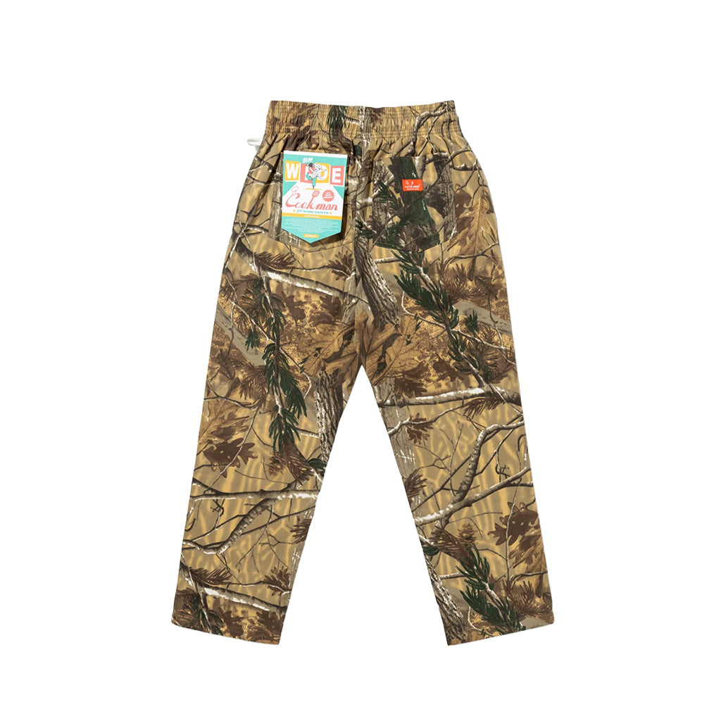 Camouflage pants with a visible brand tag on a white background