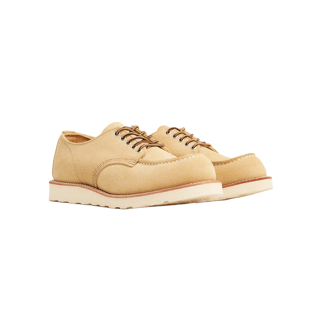 Tan leather shoe with white sole on a white background
