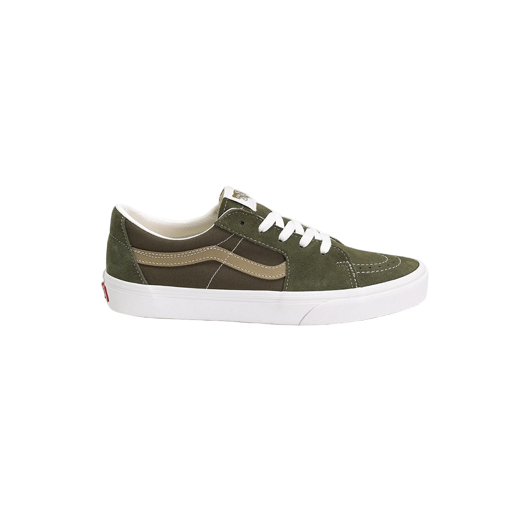 Green sneaker with white laces on a light gray background