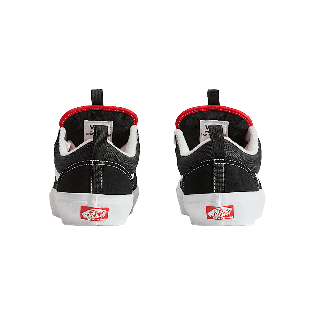 Black and white sneakers with red accents on a white background