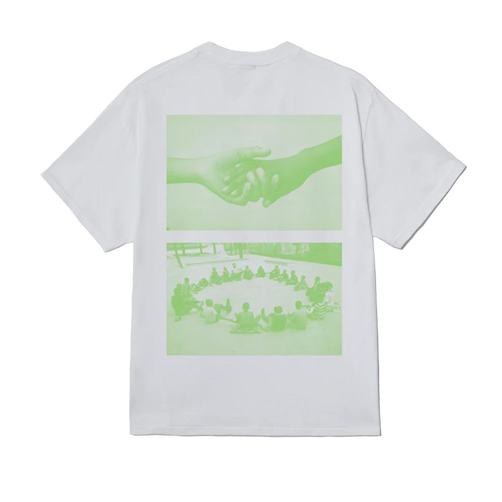White t-shirt with green graphic on the back showing a handshake and people sitting around a table.