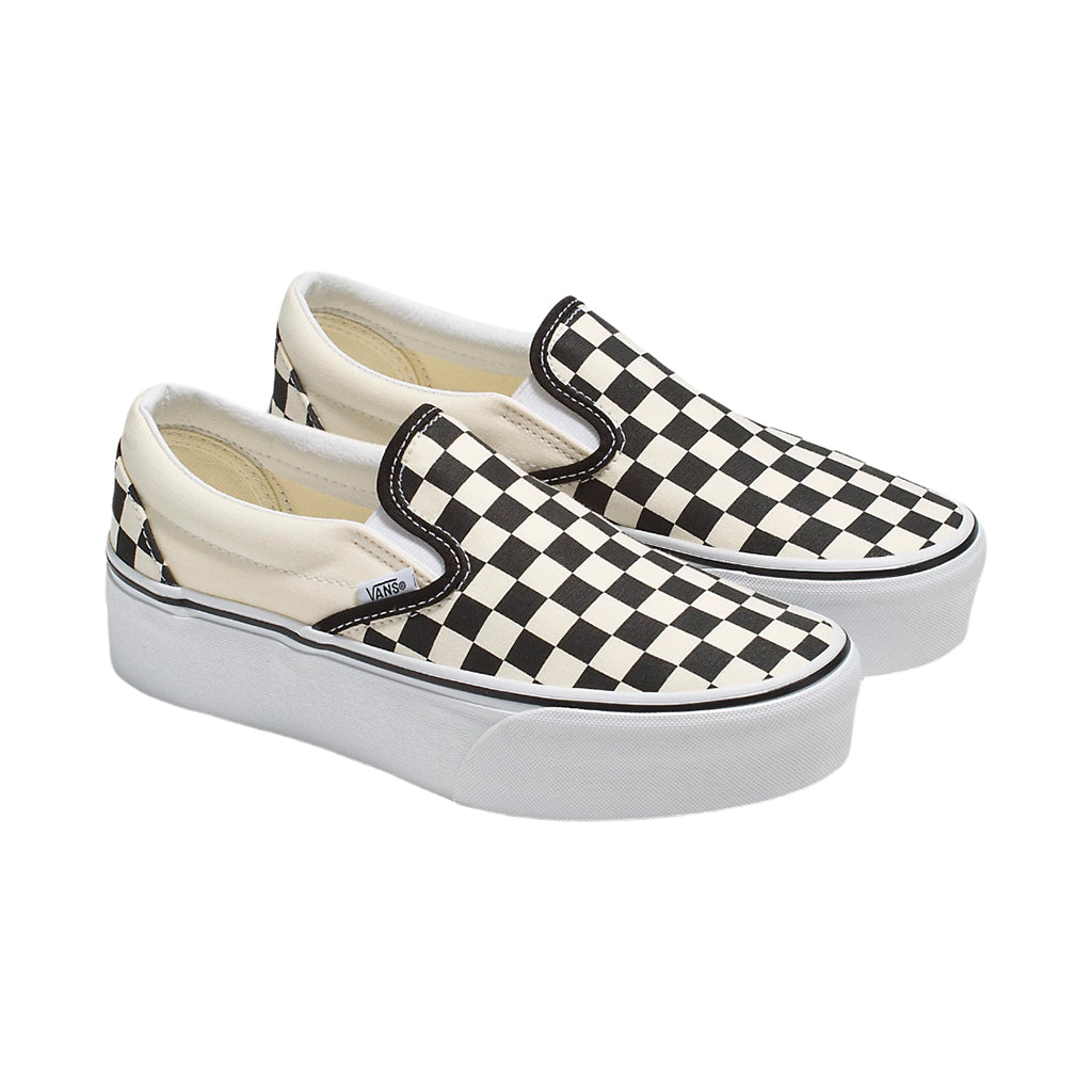 Pair of black and white checkered slip-on shoes on a white background