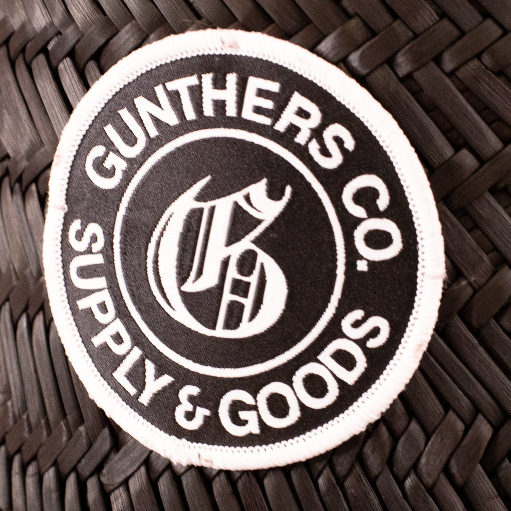Round patch with 'Gunthers Co. Supply & Goods' text and logo on a woven surface