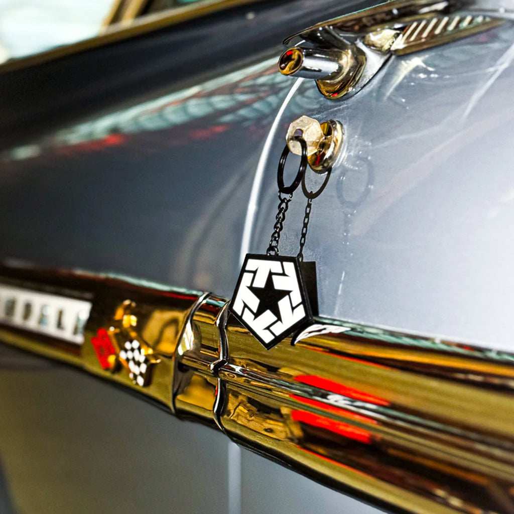 Decorative car emblem with star design on a vehicle's hood