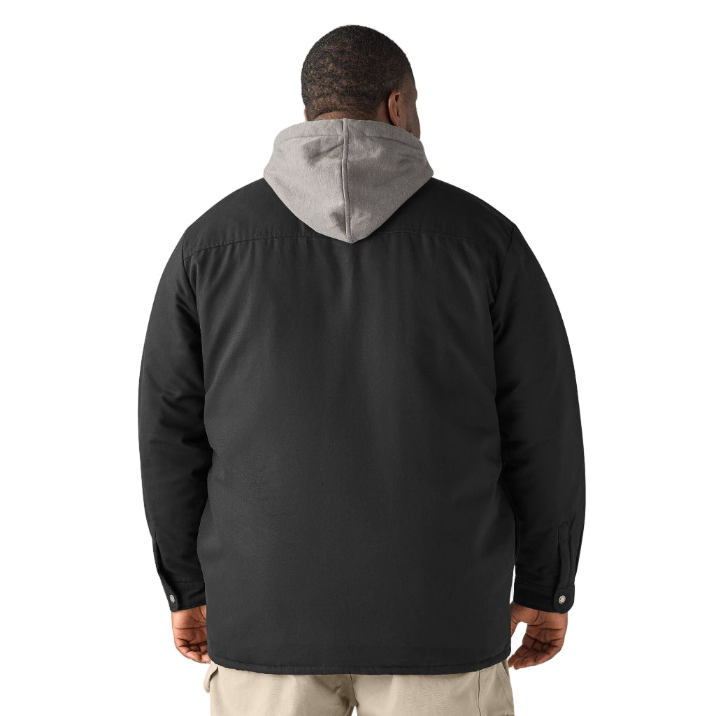 Person wearing a black jacket with a gray hood on a white background
