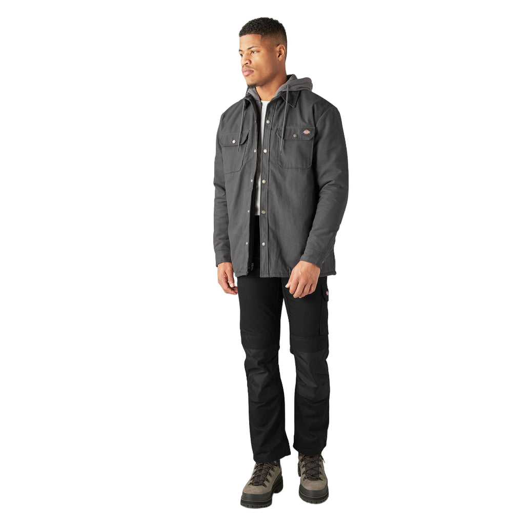 Man wearing a gray jacket and black pants on a white background